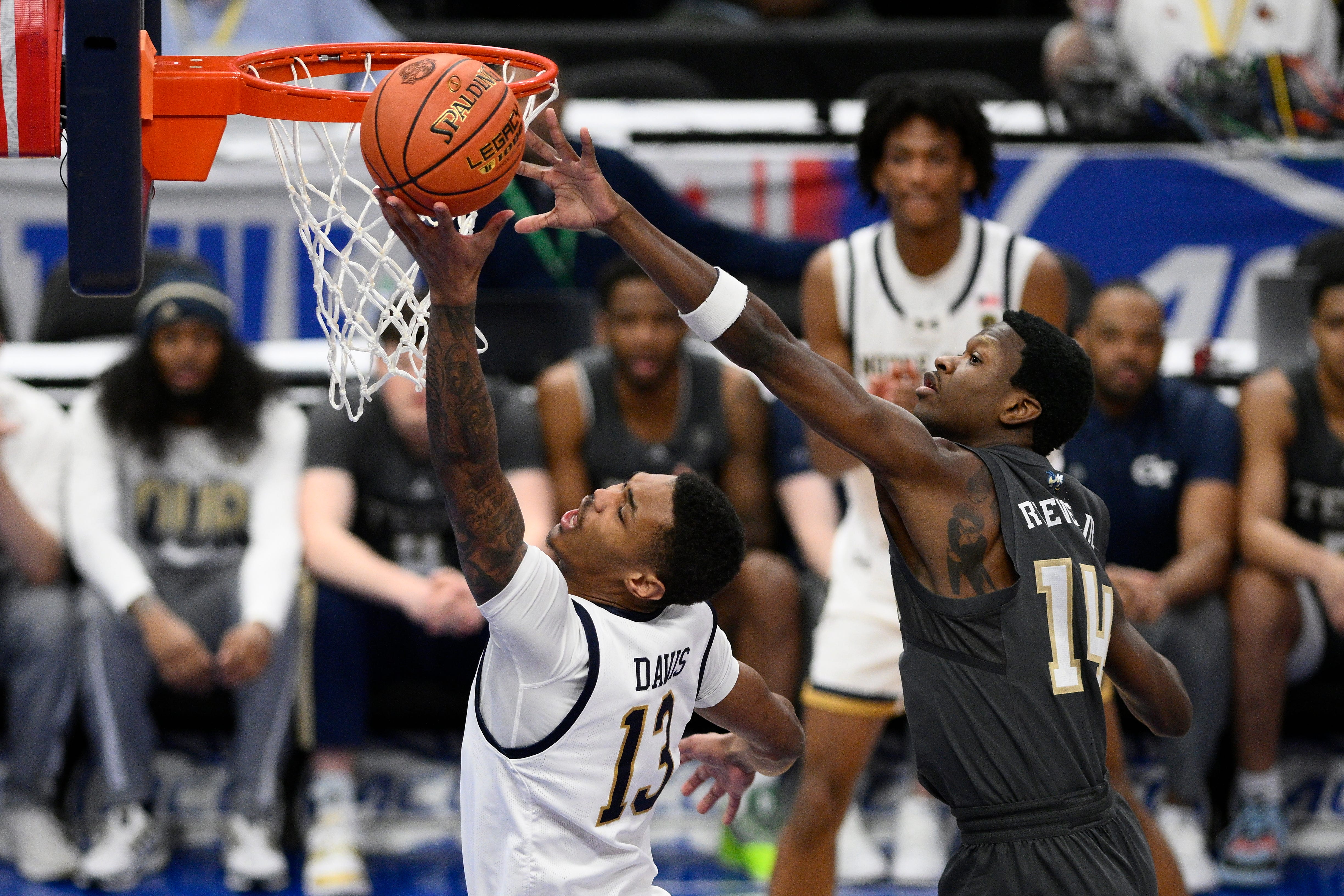 Notre Dame forward Tae Davis (13) drives to the basket against Georgia Tech guard Kowacie Reeves Jr. (14) during the first half of the Atlantic Coast Conference NCAA college basketball tournament Tuesday, March 12, 2024, in Washington. (AP Photo/Nick Wass)