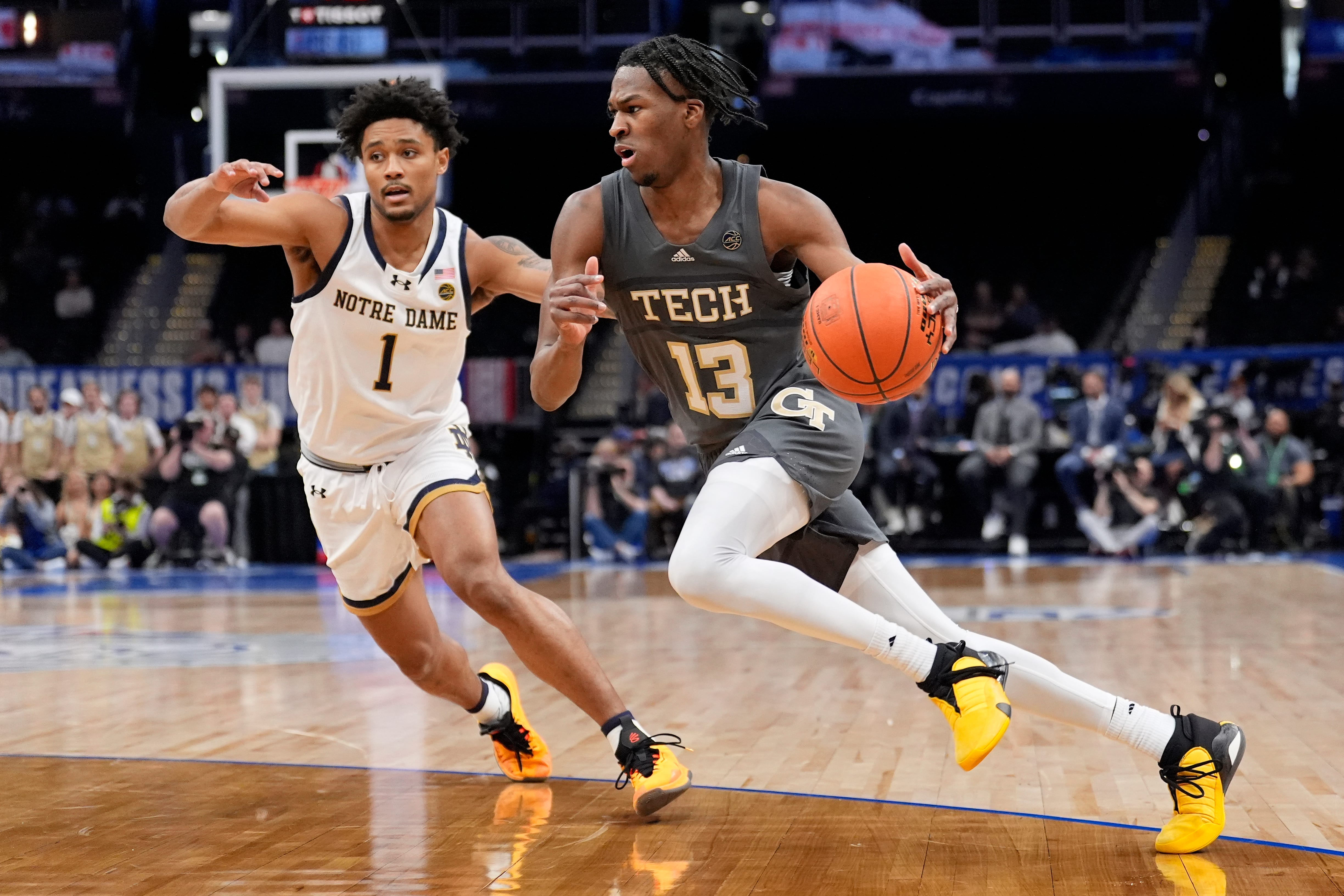 Georgia Tech guard Miles Kelly (13) driving to the basket against Notre Dame guard Julian Roper II (1) during the first half of the Atlantic Coast Conference NCAA college basketball tournament, Tuesday, March 12, 2024, in Washington. (AP Photo/Alex Brandon)