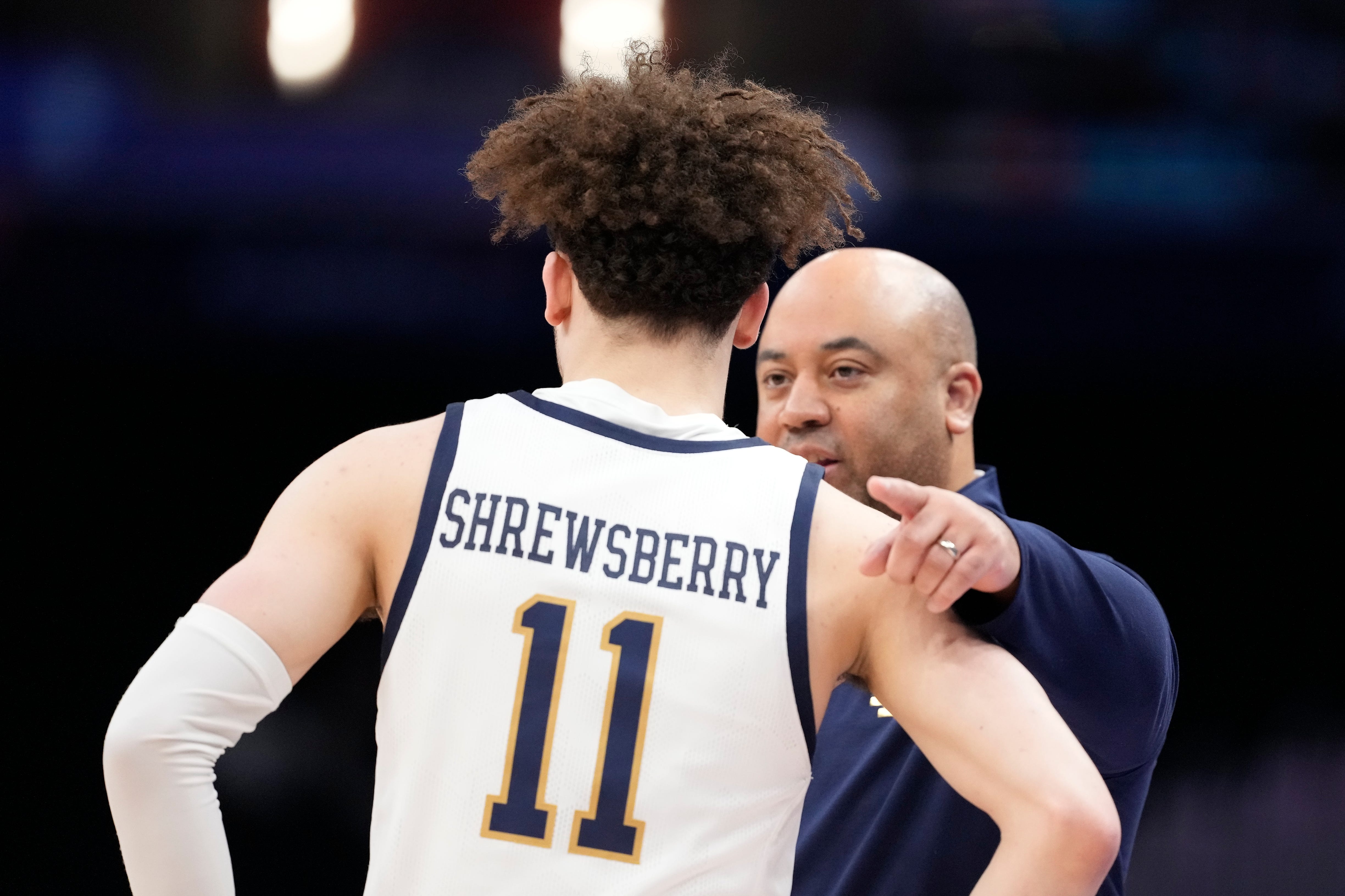 Notre Dame head coach Micah Shrewsberry talks to guard Braeden Shrewsberry (11) during the first half of the Atlantic Coast Conference NCAA college basketball tournament game against Georgia Tech, Tuesday, March 12, 2024, in Washington. (AP Photo/Alex Brandon)