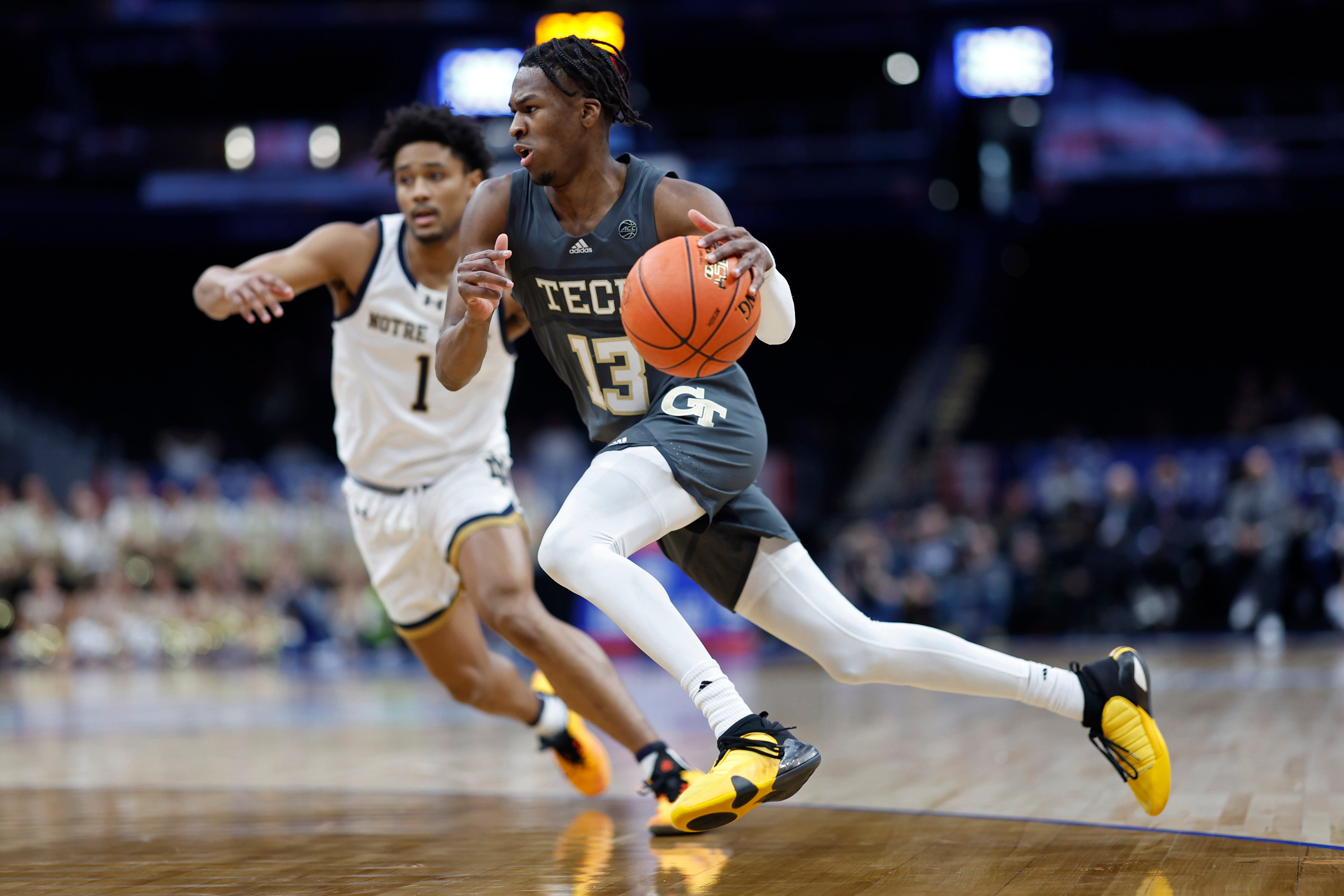 Mar 12, 2024; Washington, D.C., USA; Georgia Tech Yellow Jackets guard Miles Kelly (13) drives to the basket as Notre Dame Fighting Irish guard Julian Roper II (1) defends in the first half at Capital One Arena. Mandatory Credit: Geoff Burke-USA TODAY Sports