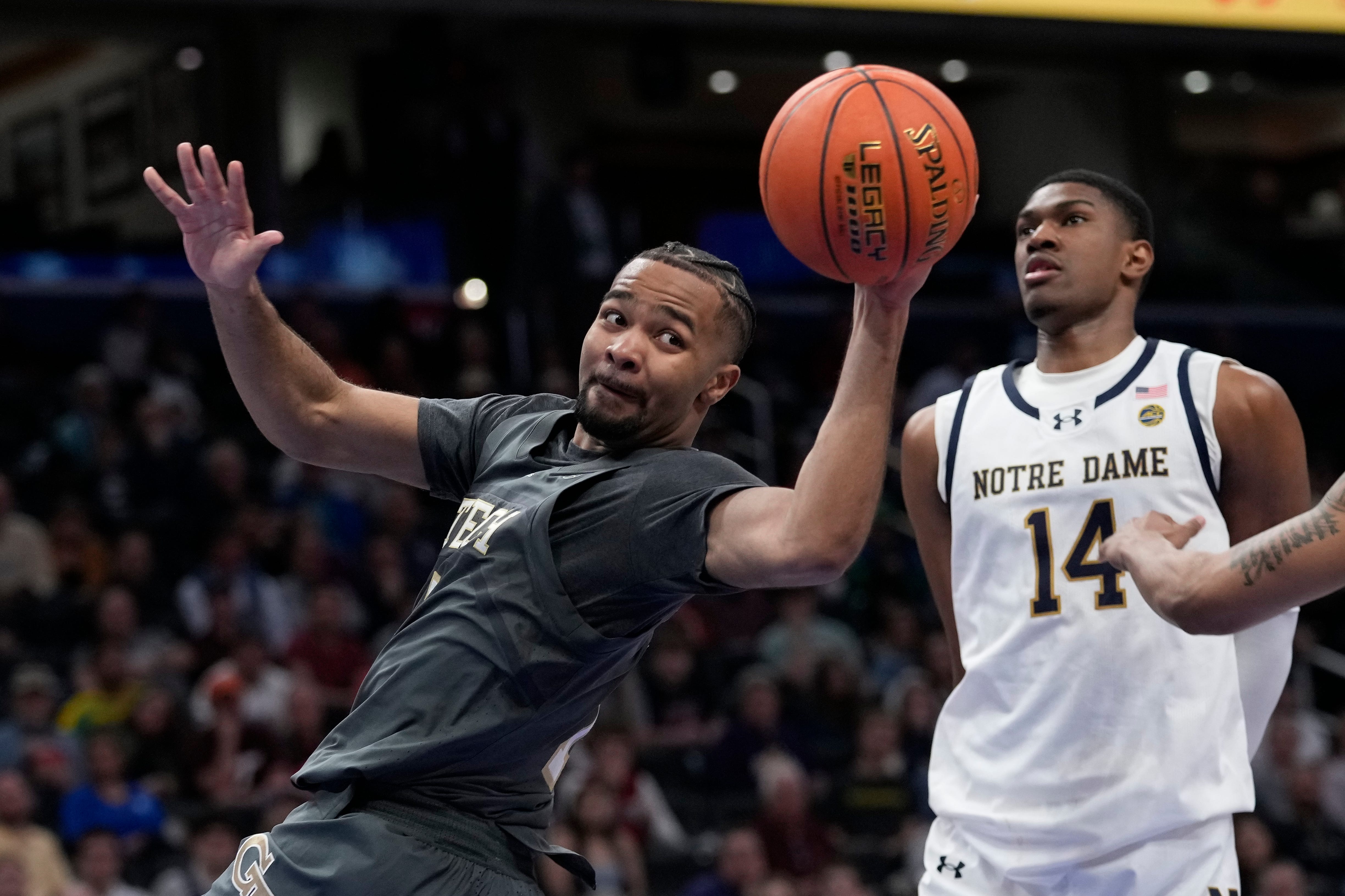 Georgia Tech guard Kyle Sturdivant (1) looks to pass the ball while going against Notre Dame forward Kebba Njie (14) during the second half of the Atlantic Coast Conference NCAA college basketball tournament, Tuesday, March 12, 2024, in Washington. (AP Photo/Susan Walsh)