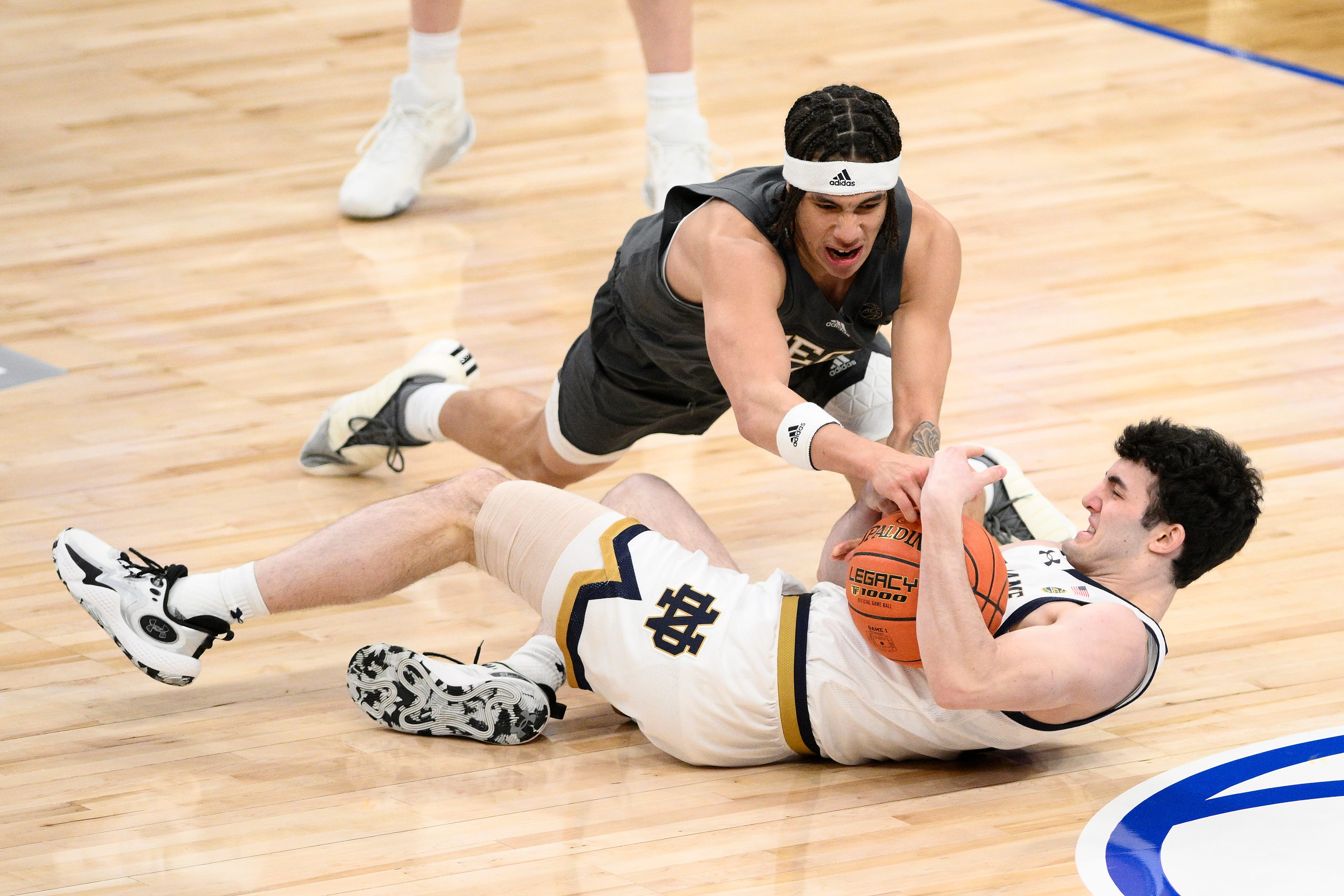 Georgia Tech guard Naithan George (2) and Notre Dame guard Logan Imes (2) battle for the loose ball during the second half of the Atlantic Coast Conference NCAA college basketball tournament, Tuesday, March 12, 2024, in Washington. (AP Photo/Nick Wass)