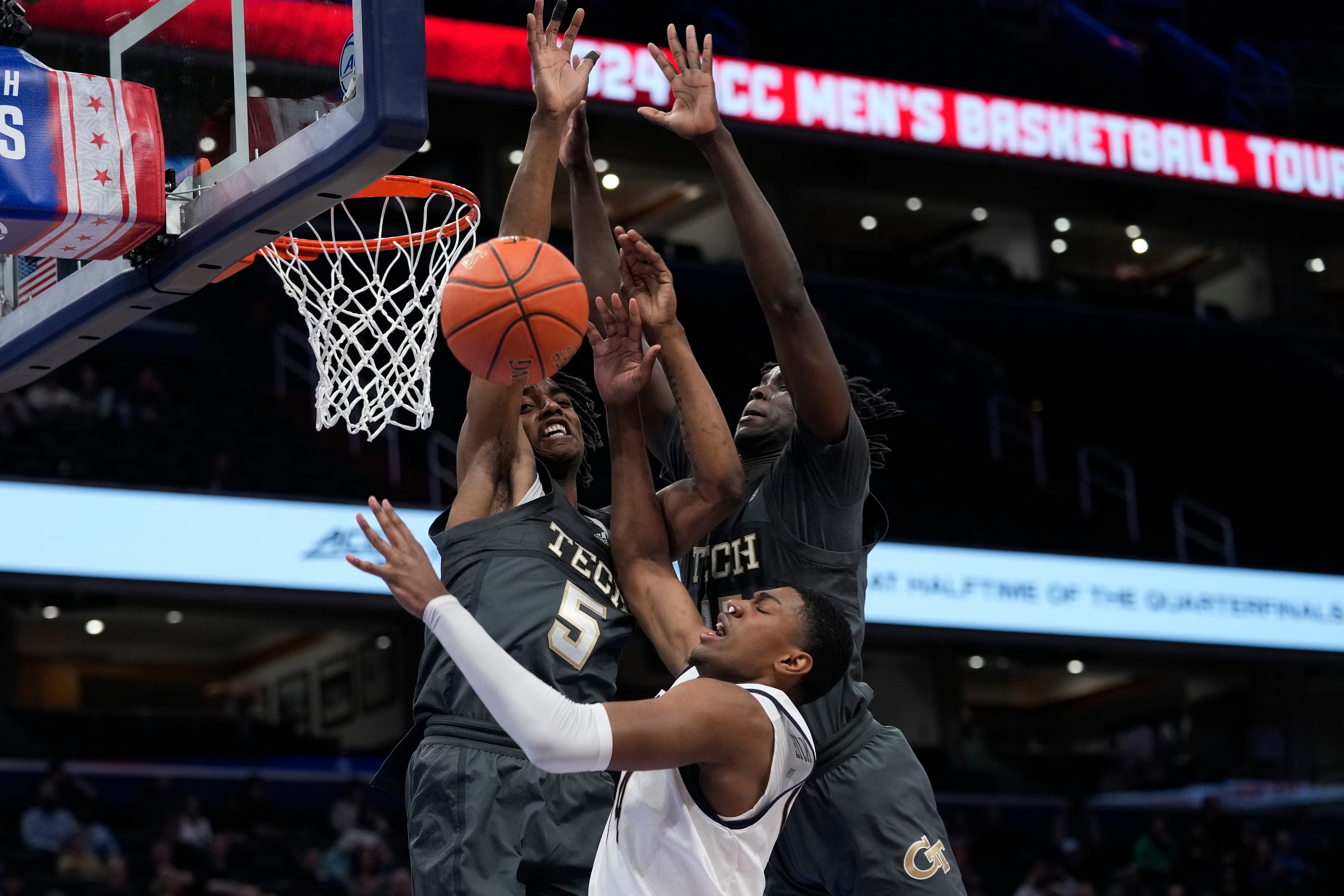 Notre Dame forward Kebba Njie (14) is blocked under the basket by Georgia Tech forwards Tafara Gapare (5) and Baye Ndongo (11) during the first half of the Atlantic Coast Conference NCAA college basketball tournament, Tuesday, March 12, 2024, in Washington. (AP Photo/Susan Walsh)