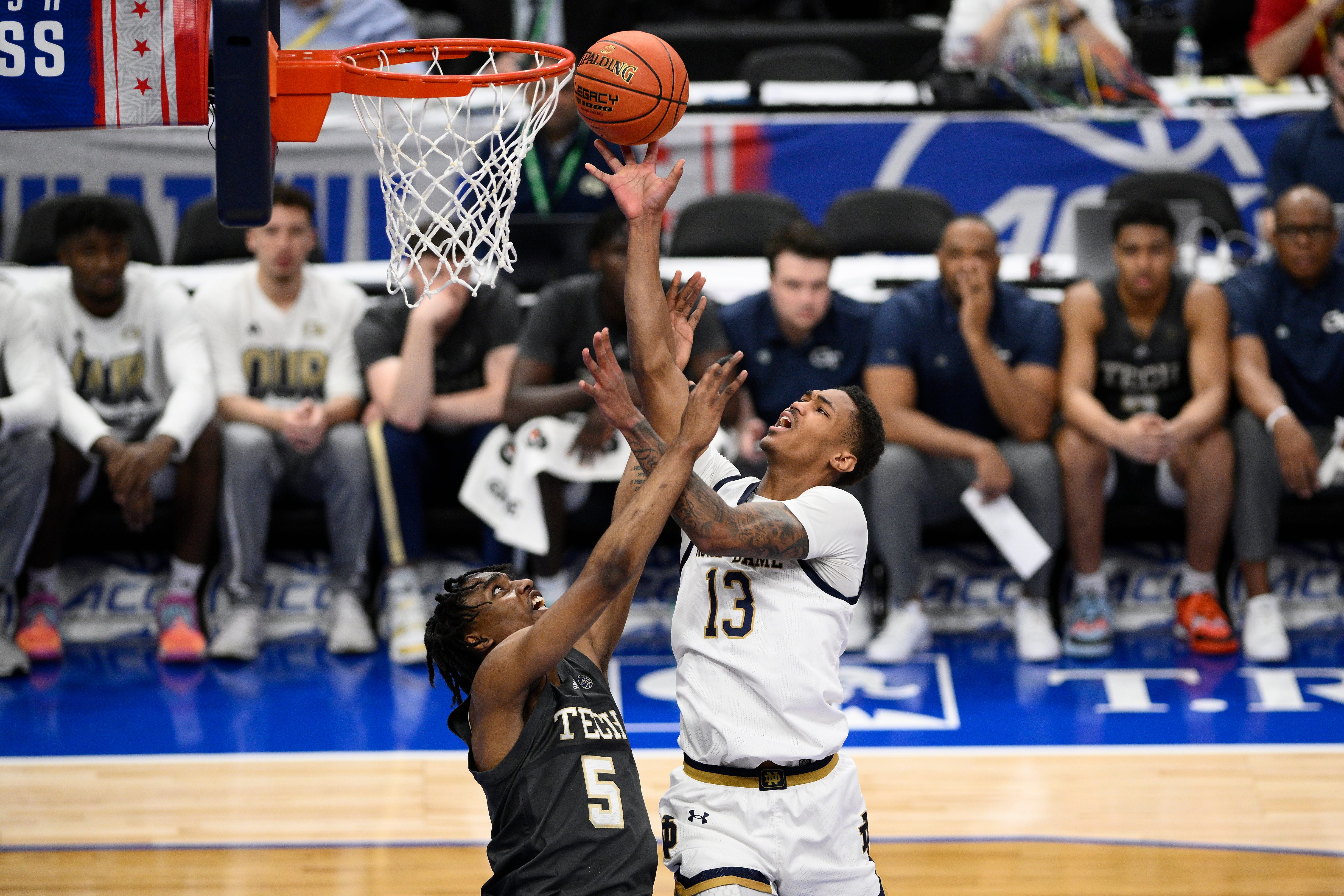 Notre Dame forward Tae Davis (13) drives to the basket against Georgia Tech forward Tafara Gapare (5) during the first half of the Atlantic Coast Conference NCAA college basketball tournament, Tuesday, March 12, 2024, in Washington. (AP Photo/Nick Wass)