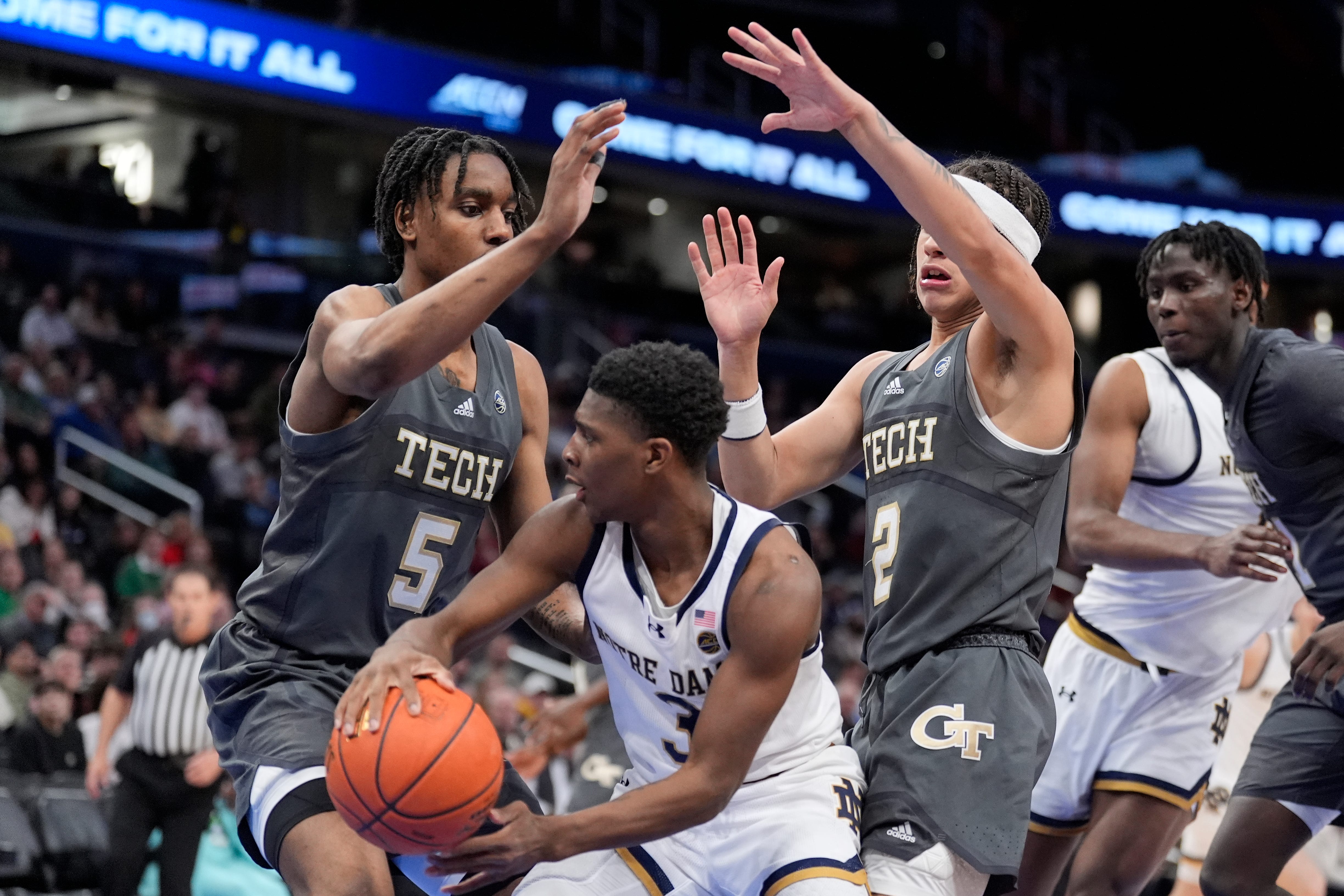 Notre Dame guard Markus Burton (3) looking to pass the ball past Georgia Tech forward Tafara Gapare (5) and guard Naithan George (2) during the second half of the Atlantic Coast Conference NCAA college basketball tournament, Tuesday, March 12, 2024, in Washington. (AP Photo/Alex Brandon)