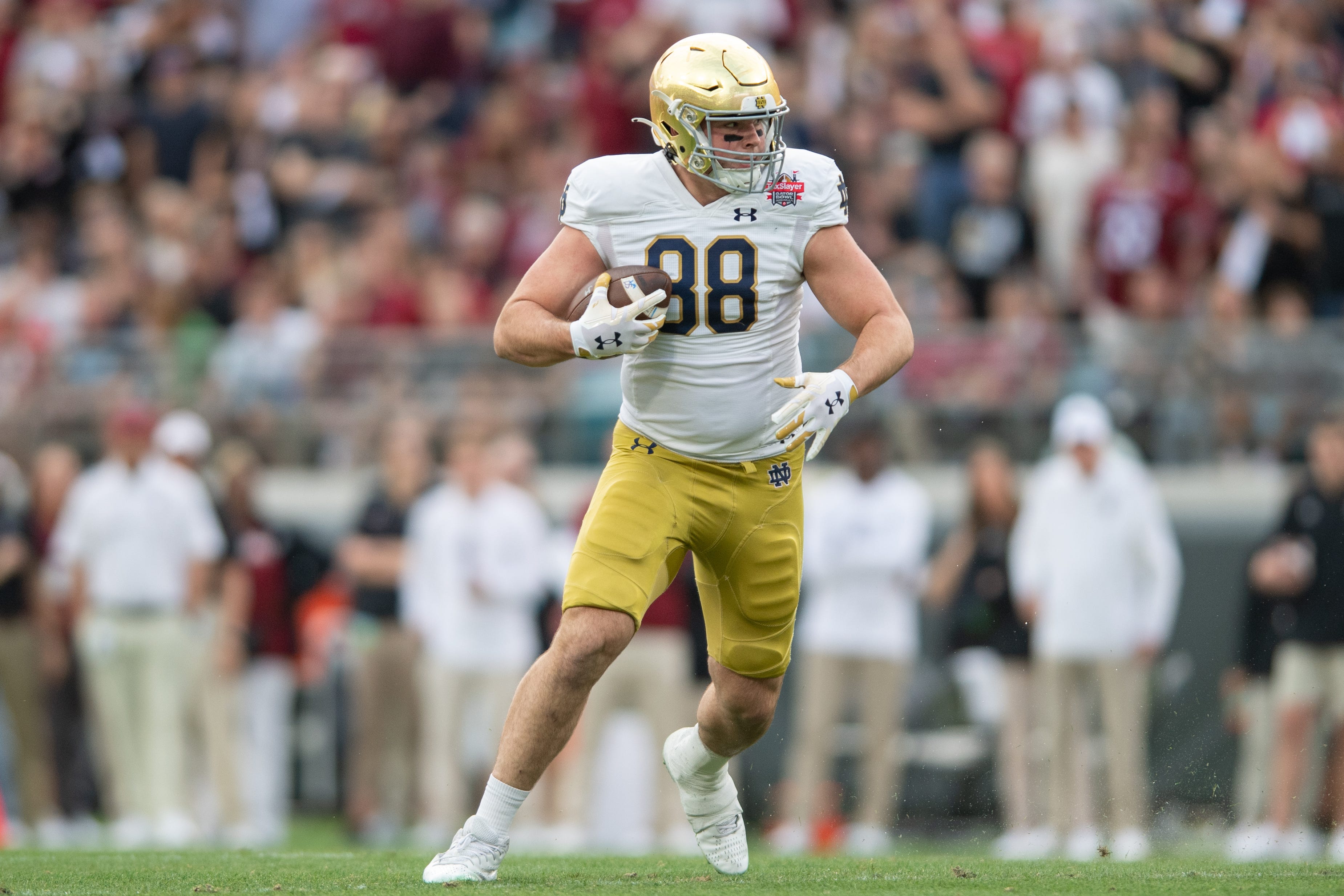 Dec 30, 2022; Jacksonville, FL, USA; Notre Dame Fighting Irish tight end Mitchell Evans (88) runs the ball after the catch against the South Carolina Gamecocks in the first quarter in the 2022 Gator Bowl at TIAA Bank Field. Mandatory Credit: Jeremy Reper-USA TODAY Sports