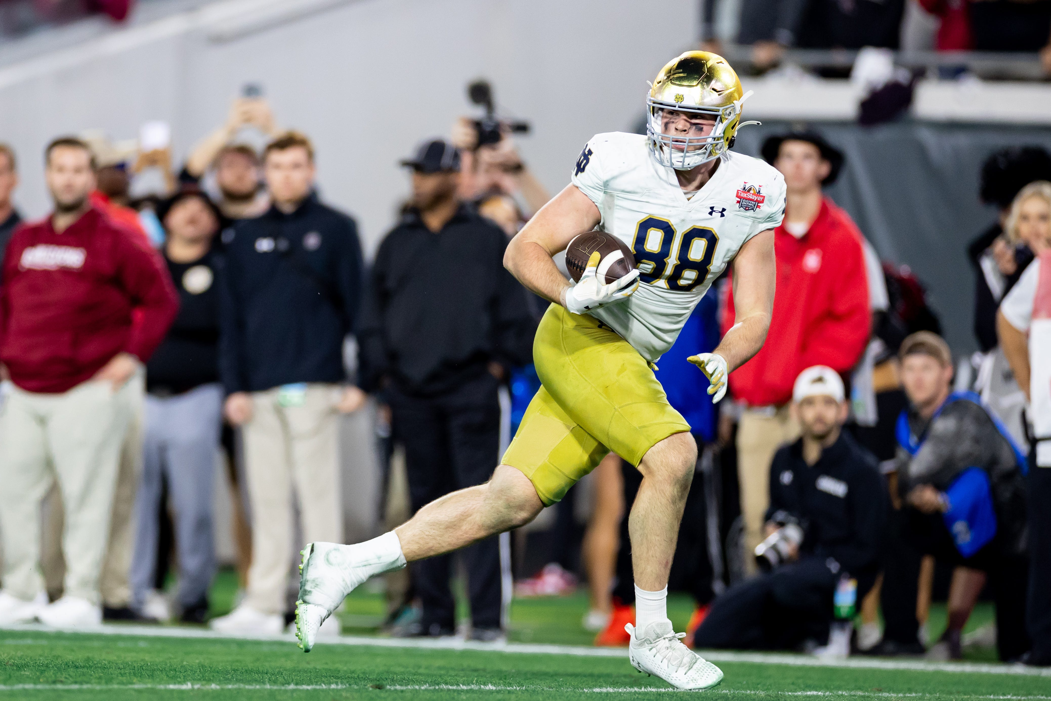 Dec 30, 2022; Jacksonville, FL, USA; Notre Dame Fighting Irish tight end Mitchell Evans (88) runs with the ball for a touchdown during the second half against the South Carolina Gamecocks in the 2022 Gator Bowl at TIAA Bank Field. Mandatory Credit: Matt Pendleton-USA TODAY Sports
