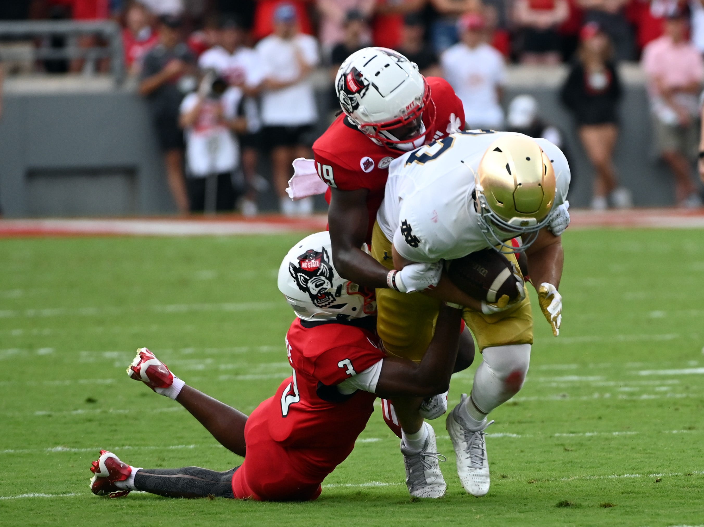 Sep 9, 2023; Raleigh, North Carolina, USA; Notre Dame Fighting Irish tight end Mitchell Evans (88) runs after a catch and is tackled by North Carolina State Wolfpack cornerback Aydan White (3) during the first half at Carter-Finley Stadium. Mandatory Credit: Rob Kinnan-USA TODAY Sports