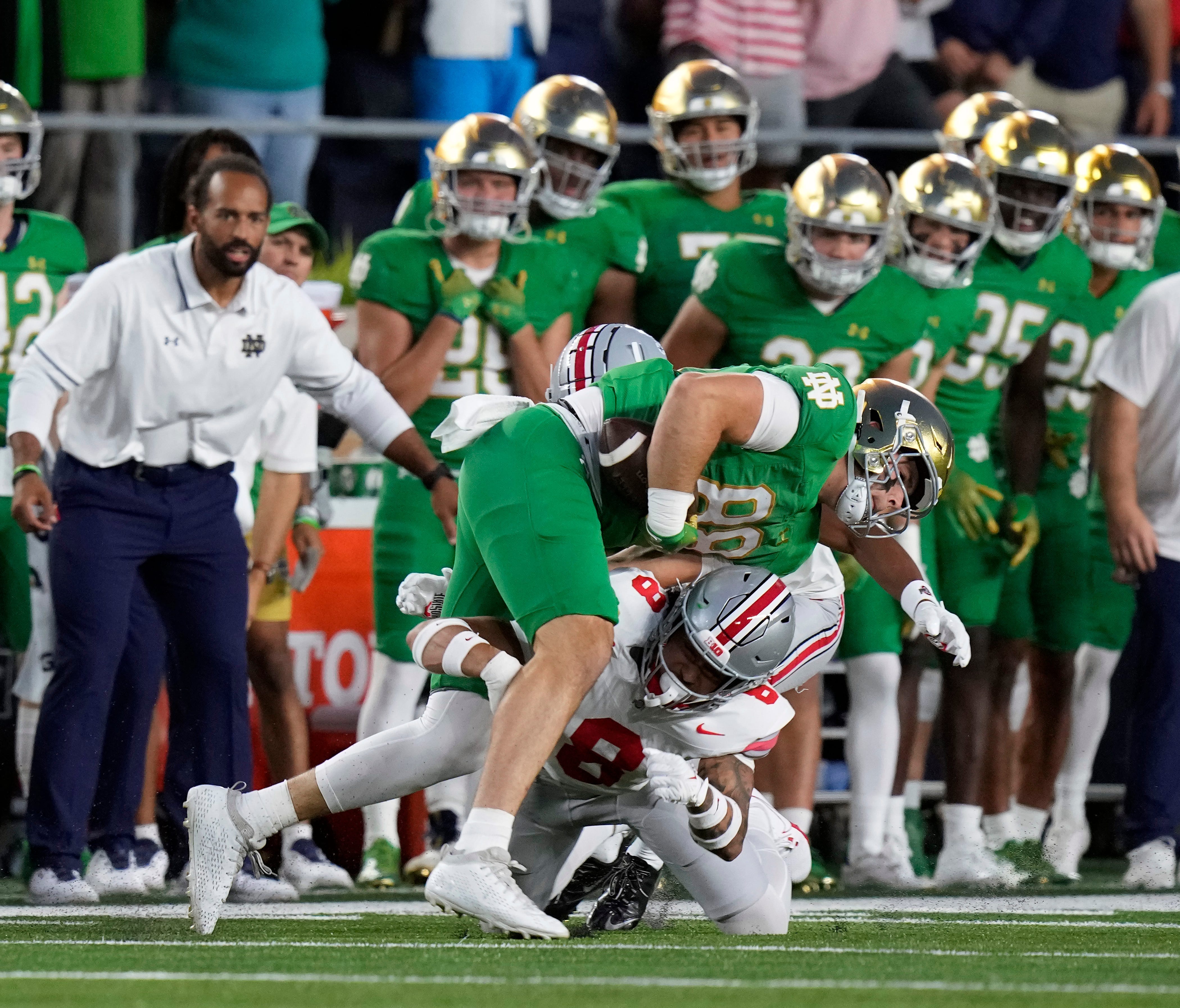 Sep 23, 2023; South Bend, Indiana, USA; Ohio State Buckeyes safety Lathan Ransom (8) tackles Notre Dame Fighting Irish tight end Mitchell Evans (88) after a catch during the first quarter of their game at Notre Dame Stadium.