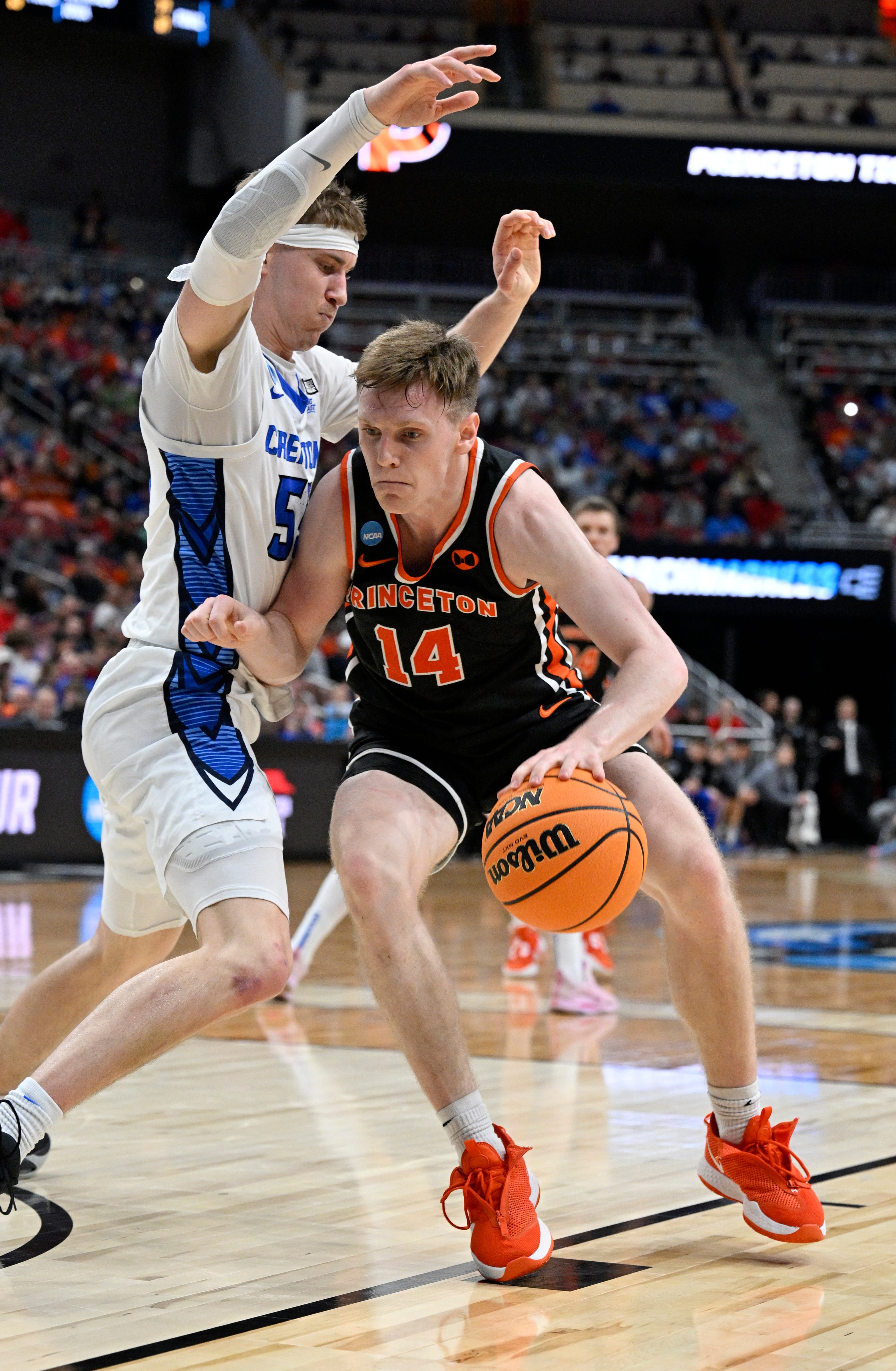 Mar 24, 2023; Louisville, KY, USA; Princeton Tigers guard Matt Allocco (14) dribbles against Creighton Bluejays guard Baylor Scheierman (55) during the second half of the NCAA tournament round of sixteen at KFC YUM! Center. Mandatory Credit: Jamie Rhodes-USA TODAY Sports